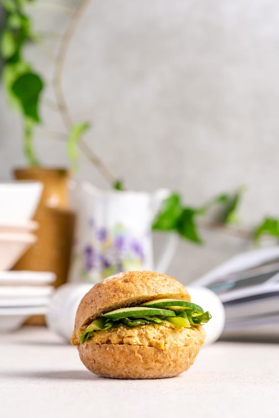Smashed avocado and fresh greens on an open-faced biscuit.