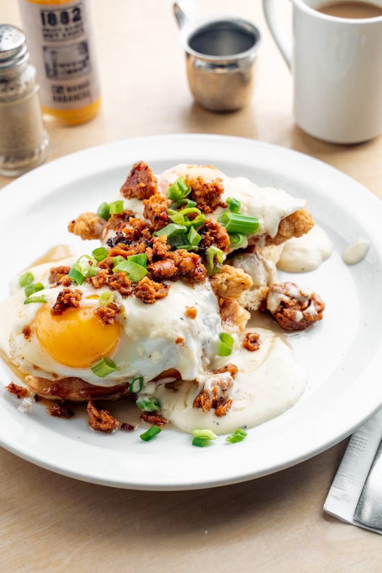 Split biscuits in white sausage gravy topped with a fried egg.