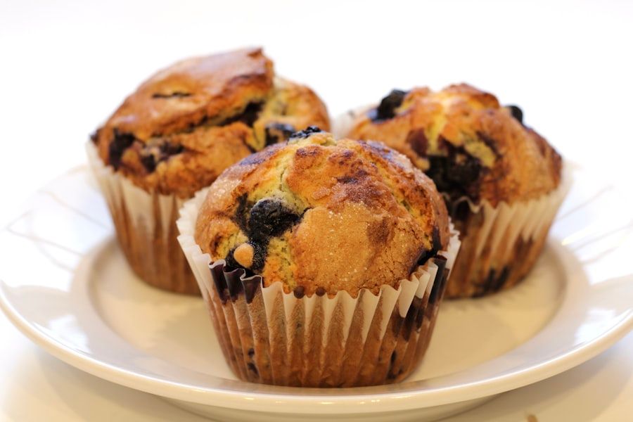 Blueberry muffins cooling on a surface.