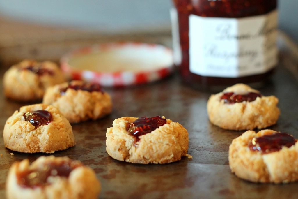 Golden buttermilk biscuits on a dark plate.