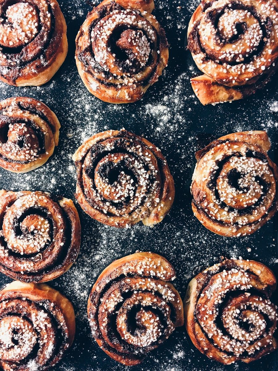 A tray of freshly baked cinnamon rolls seen from above.