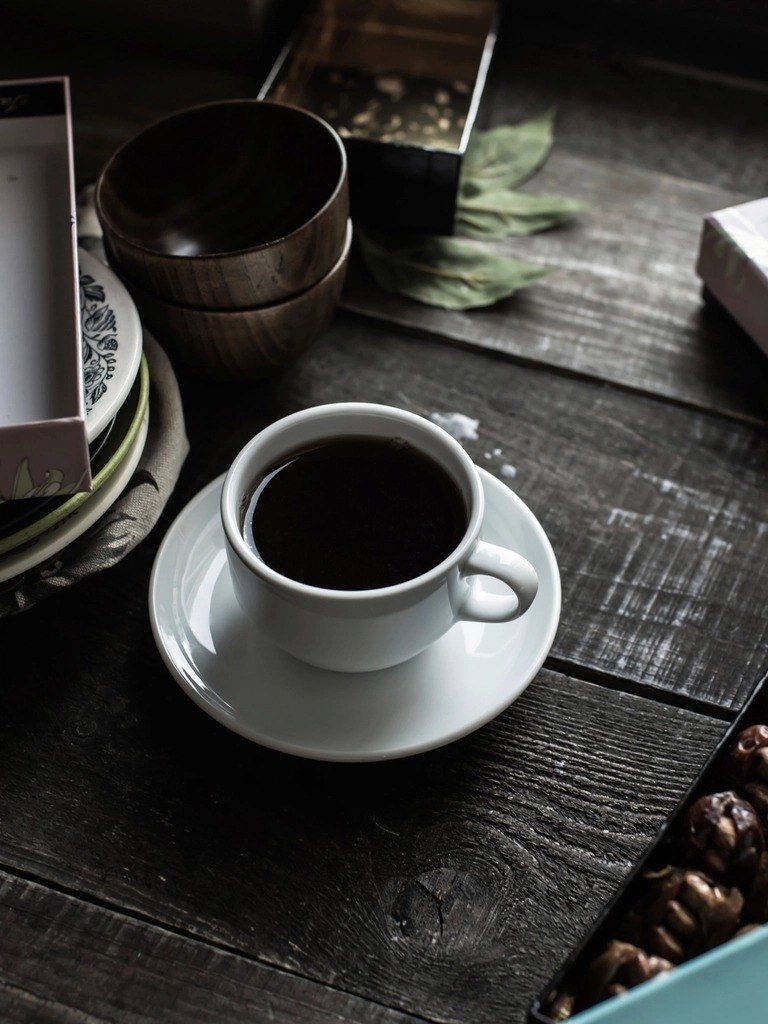 A warm cup of black drip coffee.