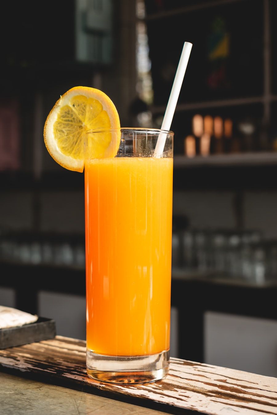 A glass of fresh orange juice with an orange slice.